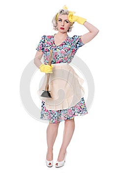 Tired fifties housewife with sink plunger, humorous concept, iso