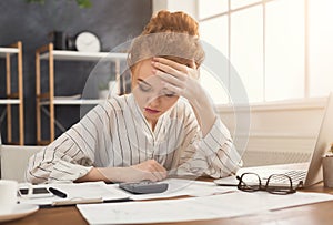 Tired financier woman working at office desktop