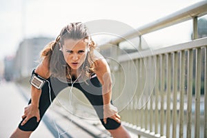 Tired fitness young woman catching breathe