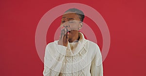 Tired funny model african american woman yawning isolated on red studio background, sleepy inattentive deprived black