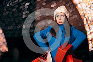 Tired Girl Holding Shopping Bags on Christmas Lights DÃ©cor