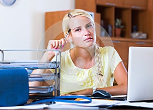 Tired girl sitting at desk