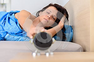 Tired groggy young woman waking up photo