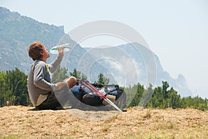 Tired hiker drinks water