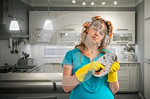 Tired housewife woman washing dishes in kitchen