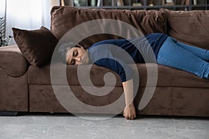 Tired Indian woman sleep on couch at home