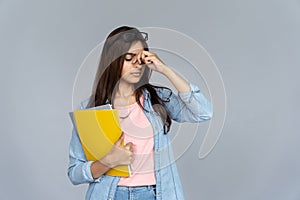 Tired indian woman student feel eye strain glasses isolated on grey background