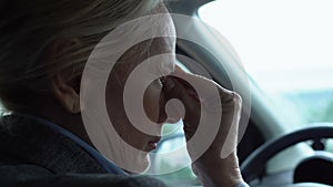 Tired lady driver stacking in traffic jam taking off eyeglasses, massaging nose