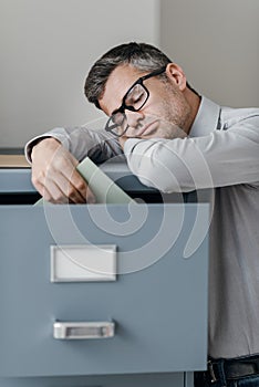 Tired office worker sleeping in the office