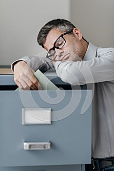 Tired office worker sleeping in the office photo