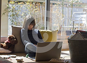 Tired lockdown kid suffering from loneliness stuck home while pandemic