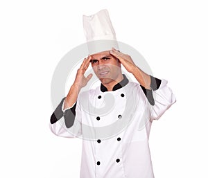 Tired male cook standing with headache