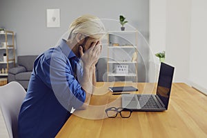 Tired male freelancer businessman in home office