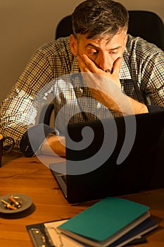 Tired male working on computer