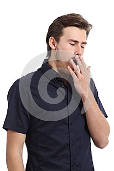 Tired man covering his mouth white yawning
