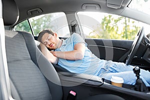 Tired man or driver sleeping in car