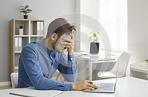 Stressed, exhausted and frustrated young employee has a burnout at work in office