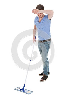 Tired Man Mopping Floor Over White Background