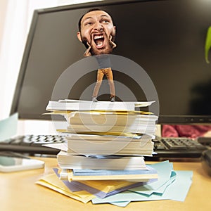 Tired man, office worker holding his huge tired head, funny
