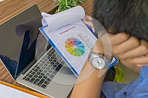 Tired man reading financial number on the report