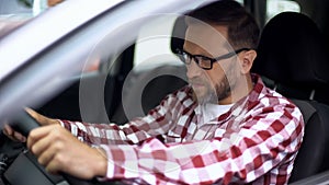 Tired man sitting in car suffering neck discomfort, spinal problem, cervicalgia photo