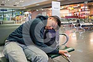 Tired man sleeping at the airport