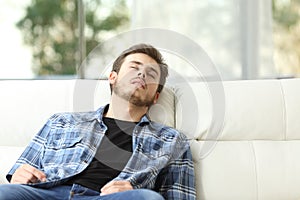 Tired man sleeping on a couch