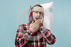 Tired man sleeping at home having too much work. Bored businessman with pillow