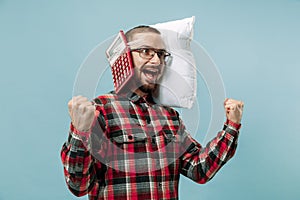 Tired man sleeping at home having too much work. Bored businessman with pillow