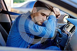 Tired man sleeps in car