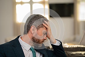 Tired man suffering from headache after computer work, exhausted with closed eyes touching head, relieving pain