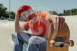 tired man touching beanie while sitting