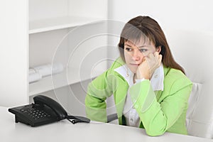 Tired manager reflects at office sitting at table