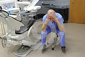 Tired mature dentist with eyes problem