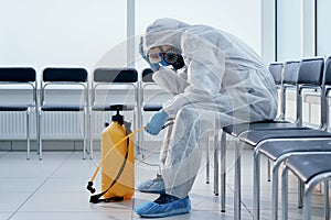 tired medical orderly in a biohazard suit.