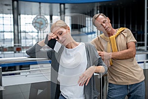 Tired middle-aged tourist couple at the airport terminal