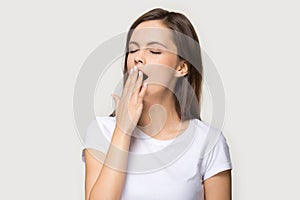 Tired young woman yawning having sleep deprivation photo