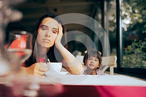 Tired Mom in Desperate Need of a Cup of Coffee in a Restaurant