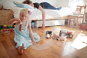 Tired mom, sleeping and girl playing with toys on floor lonely, neglect and fatigue at home. Parenting, fail and mother photo