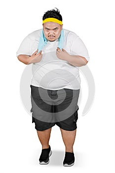 Tired obese man running in the studio