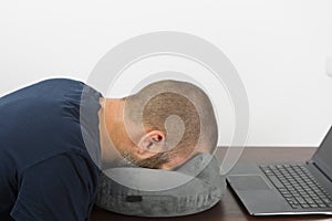 Tired office clerk lies face down on the pillow. Concept of Death from overwork photo