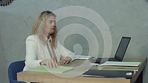 Tired office woman taking a nap at office desk