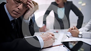 Tired office worker feeling scared, suffering at meeting with terror lady boss