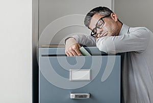 Tired office worker sleeping in the office photo