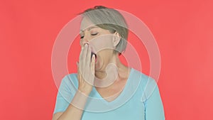 Tired Old Woman Yawning on Red Background