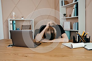 Tired  overworking businesswoman at workplace in office, holding her head in hands and thinking about successful financial strateg