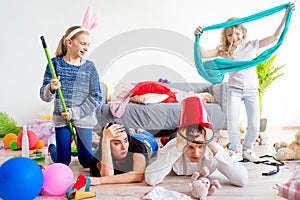 Tired parents and romping kids photo