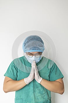 Tired praying doctor at the hospital. A doctor, a nurse who is thinking about treating a disease and a pandemic. Surgeon after