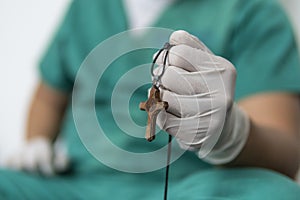 Tired praying doctor at the hospital. A doctor, a nurse who is thinking about treating a disease and a pandemic. Surgeon after