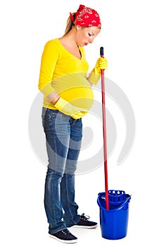 Tired pregnant woman cleaning